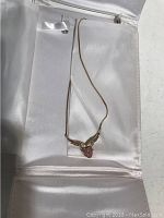 Pendant and chain in silk-lined presentation case