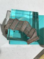 Photo of the full bracelet showing the top side with large rectangular textured segments and flexible bands.