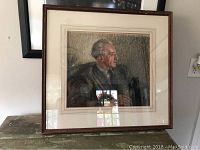 Frontal view of the full framed pastel portrait showing the man in profile, side view.