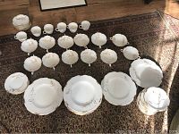 Full arrangement of approx. 58 pieces of Royal Crown Derby Devonshire pattern bone china dinnerware including plates, cups, bowls.