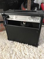 Back side view of the black Line 6 Spider IV 15 amplifier showing speaker and partial control panel.