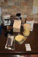 Overview photo displaying the Signor Salton espresso maker, Gevalia coffee canister, and the Ceramica De Espana ceramic olive set, along with a metal coffee filter and scoop.
