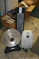 Three electric heaters including a Presto HeatDish, Delonghi tower, and Lasko ceramic heater shown together