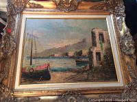 Full view of the framed oil painting showing a coastal scene with a boat and buildings.