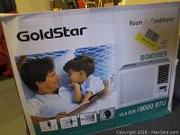 Box front showing GoldStar branding, model BG8000ER, cooling capacity 8000 BTU, 10.8 EER, image of unit and remote control.
