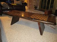Angled side view showing the wooden game table with backgammon and checkers inlaid boards and angled legs
