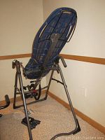 Assembled inversion table showing plastic backrest, steel frame, foam handles and ankle holders