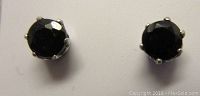 Front view of both sapphire stud earrings showing round blue sapphires in claw settings.