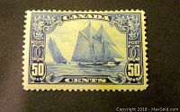 Front view of a Canadian 50 cents Blue Nose stamp showing sailing schooner design and ornate borders.