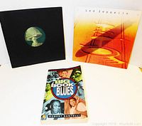 Two editions of "The Big Book of Blues" by Robert Santelli and a Led Zeppelin vinyl record with cover