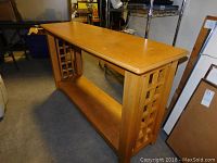 Side view of wooden sofa table showing lattice design and lower shelf