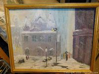 Wide view of framed painting showing a snowy urban scene with buildings, street lights, and people holding umbrellas.