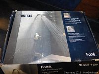 Full view of the original box showing Kohler Forté Bath and Shower Set with water spray image on front and product branding.