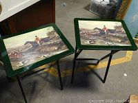 Two folding tables with hunt scene artwork and green borders, shown side-by-side