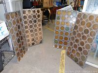 Four stained glass panels arranged in an open configuration showing circular colored glass pieces.