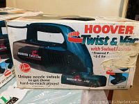 Photo of original box for Hoover Twist & Vac handheld vacuum, showing product image and branding.