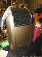 Full view of the Lasko floor standing space heater showing bronze casing and black vent grille.