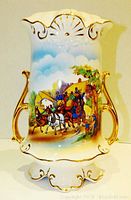 Full view of the Royal Fenton porcelain lamp base showing hand-painted horse-drawn carriage scene, gold gilded handles, and scalloped base.