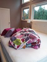 Duvet cover and decorative pillows arranged on bed