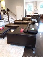 Overall view of the sectional in living room showing chaise on left and adjustable headrests raised.