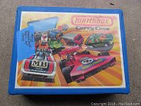 Closed blue plastic Matchbox Carry Case with colorful graphic of toy cars and Matchbox branding