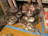 Photo of matching 1847 Rogers silverplate tea and coffee pots, cream pitcher, sugar bowl, and large serving tray with monograms. Some tarnish and light use evident.