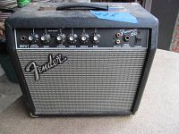 Front view of Fender Frontman 15G amplifier showing Fender logo, control knobs for volume, gain, treble, middle, bass, and input jack.