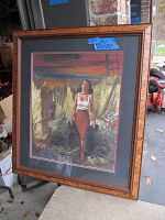 Full view of the framed art print showing the woman carrying buckets with red sunset and industrial background.