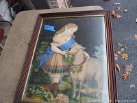 Full view of the framed print titled "My Playmate" showing a girl with a goat outdoors, framed in walnut with gold trim.
