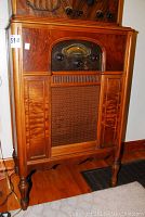 Full front view of the radio showing wood cabinet and carved legs