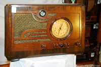 Front view of radio showing cabinet, speaker grill and dial