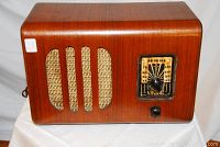 Full front view of the vintage Viking Model 864E radio showing wooden cabinet and woven fabric speaker grille with tuning dial and knob