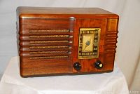 Front view of restored Westinghouse 556A radio showing wood veneer cabinet and grille