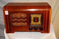Front view of Philco wooden cabinet radio showing speaker grill and tuning dial