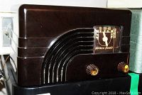 Front side view of Northern Electric Baby Champ 5000 radio showing analog dial and two brass knobs