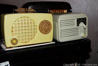 Both radios displayed side by side on black surface