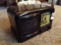 Front three-quarter view showing brown Bakelite case, horizontal grille and dial