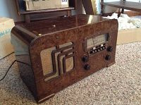 Full side view of the Motorola 1938 tabletop radio showing walnut burled wood veneer and overall condition with some wear and chips.
