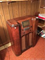 Full view of wooden console radio showing overall condition and style