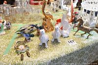 Tabletop display of assorted decorative figurines and a small clock