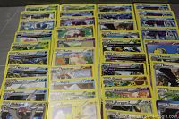 Photo showing multiple rows of Pokemon cards with yellow borders, featuring various species including Gyarados, Unfezant, Porygon-Z and others.