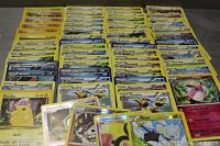 First photo showing a broad spread of various Pokémon cards, arranged in rows by type and name featuring Pokémon like Pikachu.