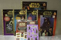 Four vintage Star Wars Golden Books activity and adventure books with colorful covers featuring key characters and scenes.