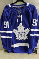 Front view of blue Toronto Maple Leafs jersey showing number 91 and team logo.