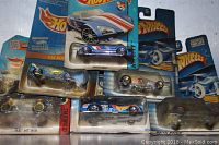 Lot of six Hot Wheels cars in original blister packaging. Packaging is damaged but cars appear intact.