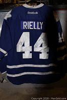 Back of the blue Toronto Maple Leafs jersey showing RIELLY and number 44 with visible dirt marks and autograph on number 4.