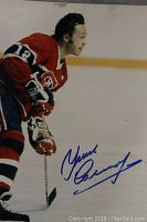 Full view of the 8x10 photo showing Yvan Cournoyer in hockey gear, signed in blue ink.