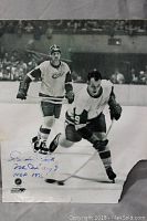 Full 8x10 autographed photo of Gordie Howe on ice with minor damage and wrinkles visible, showing overall condition and autograph location.
