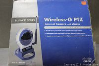 Front of box showing Linksys Wireless-G PTZ Internet Camera with Audio, model WVC200, Business Series, in blue and white packaging.