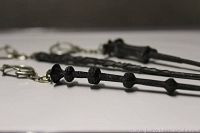Close-up showing detailed segmented pewter wand key chain with smoke damage